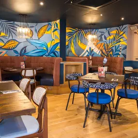 Stylish dining area at Zizzi South Woodford with modern decor and natural accents.