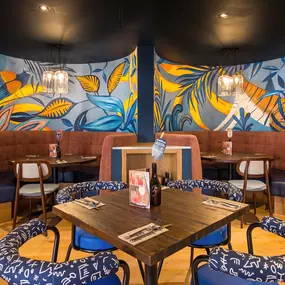 Stylish dining area at Zizzi South Woodford with modern decor and natural accents.