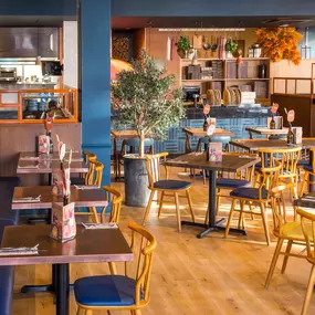 Stylish dining area at Zizzi South Woodford with modern decor and natural accents.