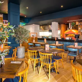 Stylish dining area at Zizzi South Woodford with modern decor and natural accents.