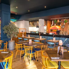 Stylish dining area at Zizzi South Woodford with modern decor and natural accents.