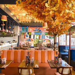 Zizzi Gloucester Quays, colourful mural wall and signature indoor tree feature.