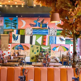 Zizzi Gloucester Quays, colourful mural wall and signature indoor tree feature.