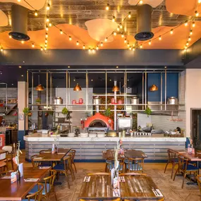 Zizzi Gloucester Quays, colourful mural wall and signature indoor tree feature.