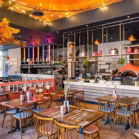 Zizzi Gloucester Quays, colourful mural wall and signature indoor tree feature.