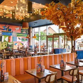 Zizzi Gloucester Quays, colourful mural wall and signature indoor tree feature.
