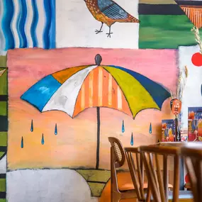 Zizzi Gloucester Quays, colourful mural wall and signature indoor tree feature.