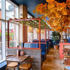 Zizzi Gloucester Quays, colourful mural wall and signature indoor tree feature.