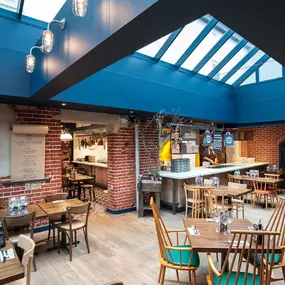 Zizzi Norwich, colourful mural wall and mixed seating styles.