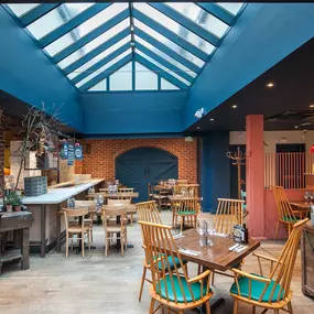 Zizzi Norwich, colourful mural wall and mixed seating styles.