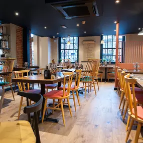 Zizzi Norwich, colourful mural wall and mixed seating styles.