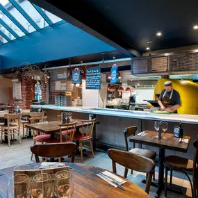 Zizzi Norwich, colourful mural wall and mixed seating styles.
