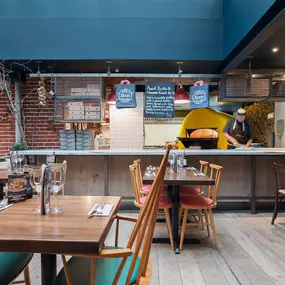 Zizzi Norwich, colourful mural wall and mixed seating styles.
