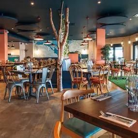 Stylish nautical-themed Zizzi Port Solent interior with warm lighting and wood finishes.
