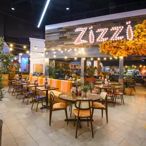 Interior view of Zizzi Sheffield Meadowhall's vibrant modern dining area at with rustic decor and natural accents.