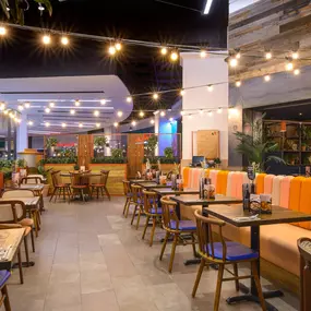 Interior view of Zizzi Sheffield Meadowhall's vibrant modern dining area at with rustic decor and natural accents.