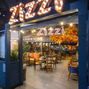 Interior view of Zizzi Sheffield Meadowhall's vibrant modern dining area at with rustic decor and natural accents.