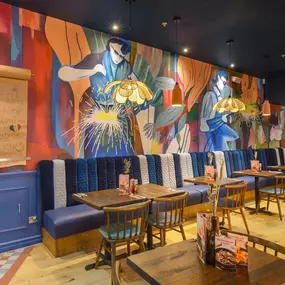Interior view of Zizzi Sheffield Meadowhall's vibrant modern dining area at with rustic decor and natural accents.