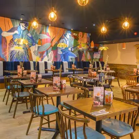Interior view of Zizzi Sheffield Meadowhall's vibrant modern dining area at with rustic decor and natural accents.