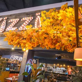 Interior view of Zizzi Sheffield Meadowhall's vibrant modern dining area at with rustic decor and natural accents.