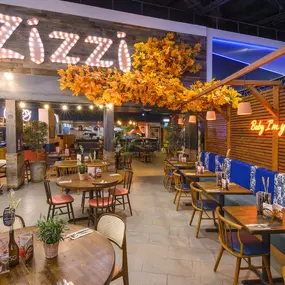 Interior view of Zizzi Sheffield Meadowhall's vibrant modern dining area at with rustic decor and natural accents.