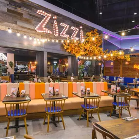 Interior view of Zizzi Sheffield Meadowhall's vibrant modern dining area at with rustic decor and natural accents.