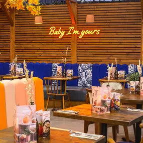 Interior view of Zizzi Sheffield Meadowhall's vibrant modern dining area at with rustic decor and natural accents.