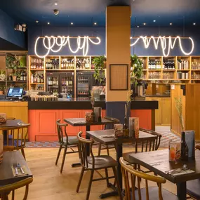 Interior view of Zizzi Sheffield Meadowhall's vibrant modern dining area at with rustic decor and natural accents.