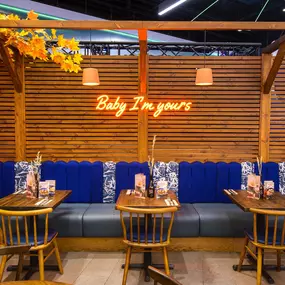 Interior view of Zizzi Sheffield Meadowhall's vibrant modern dining area at with rustic decor and natural accents.
