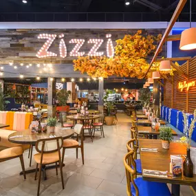 Interior view of Zizzi Sheffield Meadowhall's vibrant modern dining area at with rustic decor and natural accents.