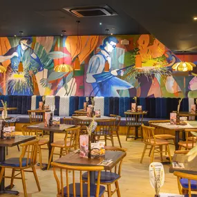 Interior view of Zizzi Sheffield Meadowhall's vibrant modern dining area at with rustic decor and natural accents.