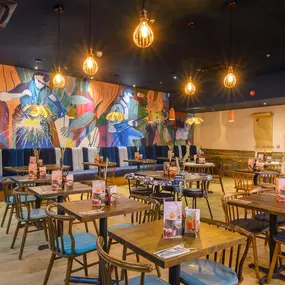 Interior view of Zizzi Sheffield Meadowhall's vibrant modern dining area at with rustic decor and natural accents.
