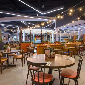 Interior view of Zizzi Sheffield Meadowhall's vibrant modern dining area at with rustic decor and natural accents.