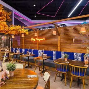 Interior view of Zizzi Sheffield Meadowhall's vibrant modern dining area at with rustic decor and natural accents.