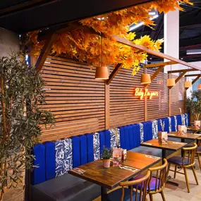 Interior view of Zizzi Sheffield Meadowhall's vibrant modern dining area at with rustic decor and natural accents.