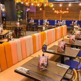Interior view of Zizzi Sheffield Meadowhall's vibrant modern dining area at with rustic decor and natural accents.