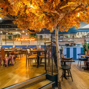 Zizzi - Birmingham Mailbox, warm seating area with canopy-like ceiling décor.