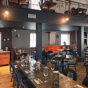 Zizzi Chichester, interior with green feature wall and wooden seating
