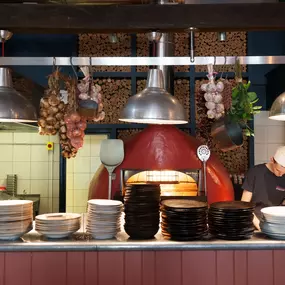 Zizzi Chichester, interior with green feature wall and wooden seating