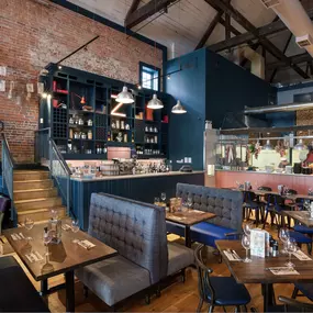 Zizzi Chichester, bright interior with brick walls create a classic design and wooden seating.
