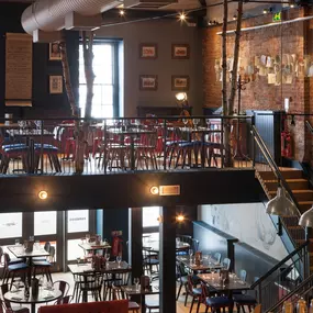 Zizzi Chichester, bright interior with brick walls create a classic design and wooden seating.