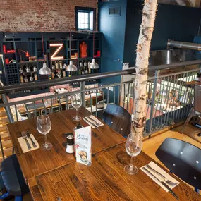Zizzi Chichester, bright interior with brick walls create a classic design and wooden seating.