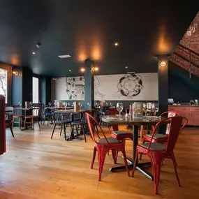 Zizzi Chichester, interior with green feature wall and wooden seating