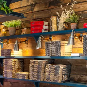 Zizzi Hereford, vibrant dining with hanging ceiling foliage and warm lighting.