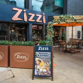 Exterior view of Zizzi Sheffield Leopold Square showing the vibrant restaurant front and outdoor dining area.