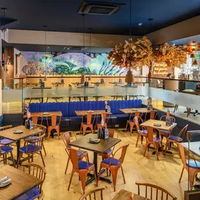 Interior view of Zizzi Sheffield Leopold Square's modern decor and rustic style accents.