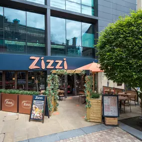 Exterior view of Zizzi Sheffield Leopold Square showing the vibrant restaurant front and outdoor dining area.