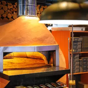 Zizzi Chiswick, showcases wooden tables and chairs beneath decorative copper foliage suspended from the ceiling.