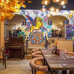 Interior view of the vibrant Zizzi Wigmore Street (near Oxford Street) with modern decor and natural accents.