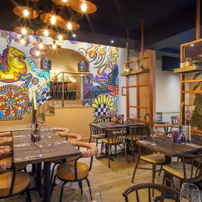 Interior view of the vibrant Zizzi Wigmore Street (near Oxford Street) with modern decor and natural accents.
